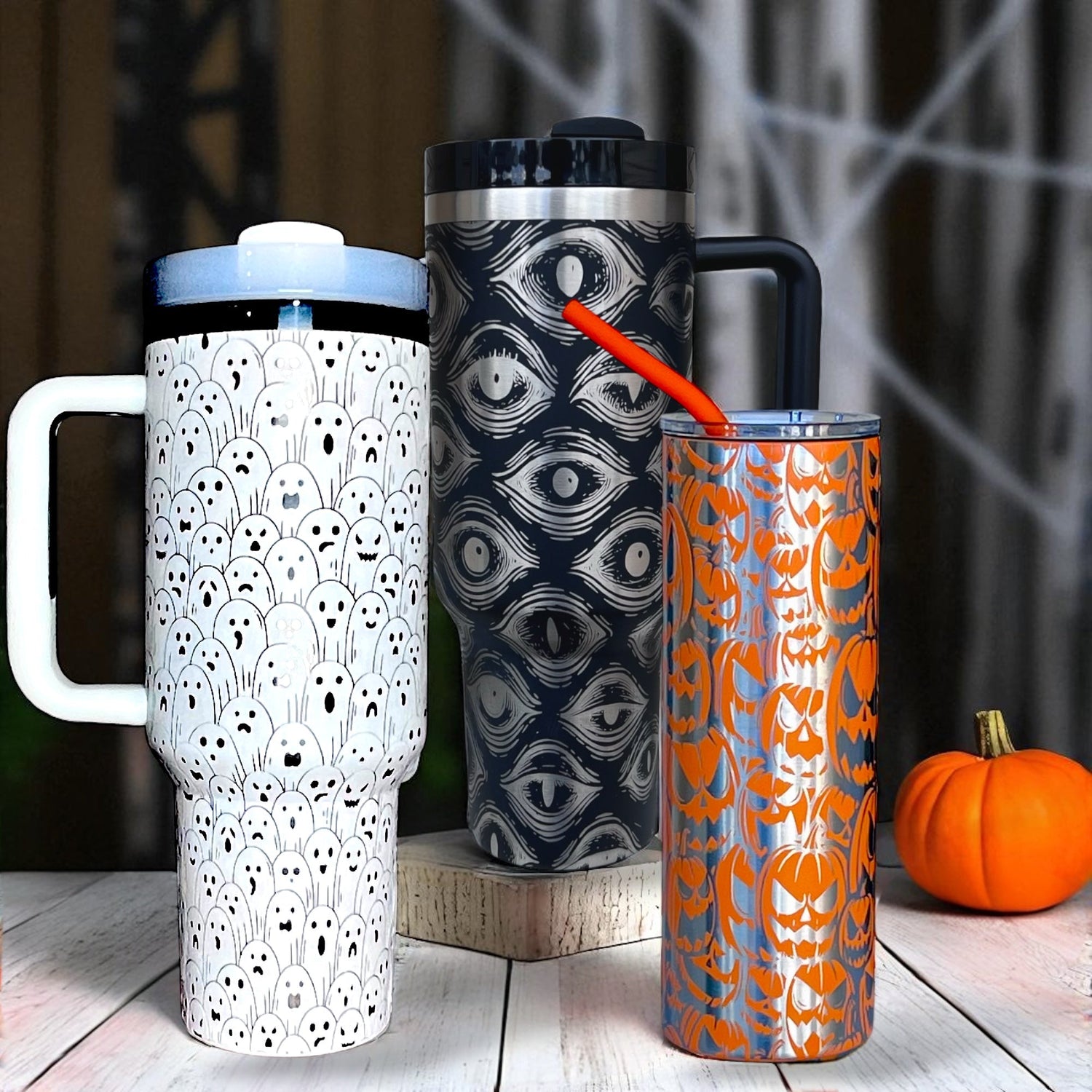 Spooky eyes on a black handle tumbler and playful ghosts on a white handle tumbler
