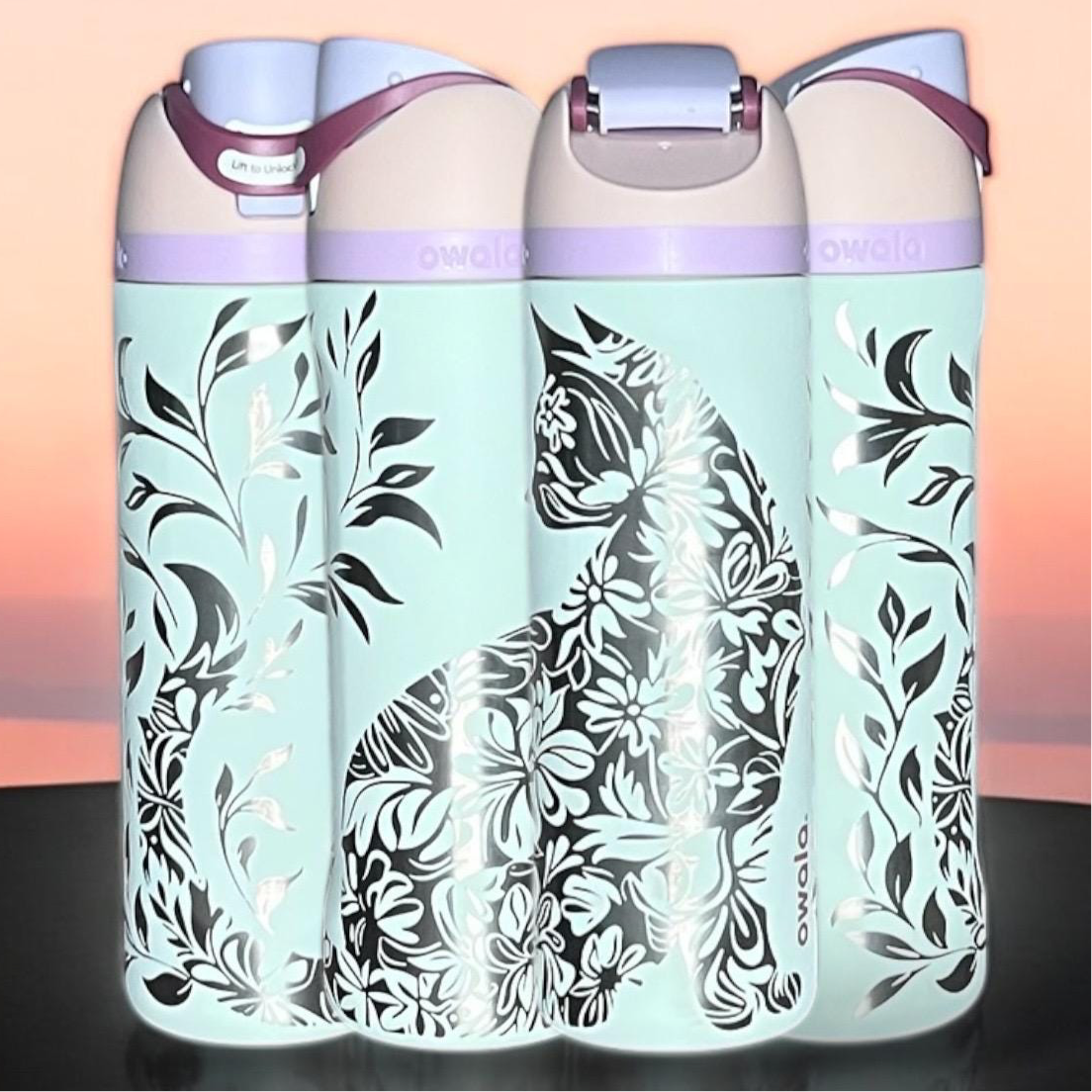 Owala Freesip 24oz water bottle with intricate full-wrap detailed floral cat engraving in coastal mist color