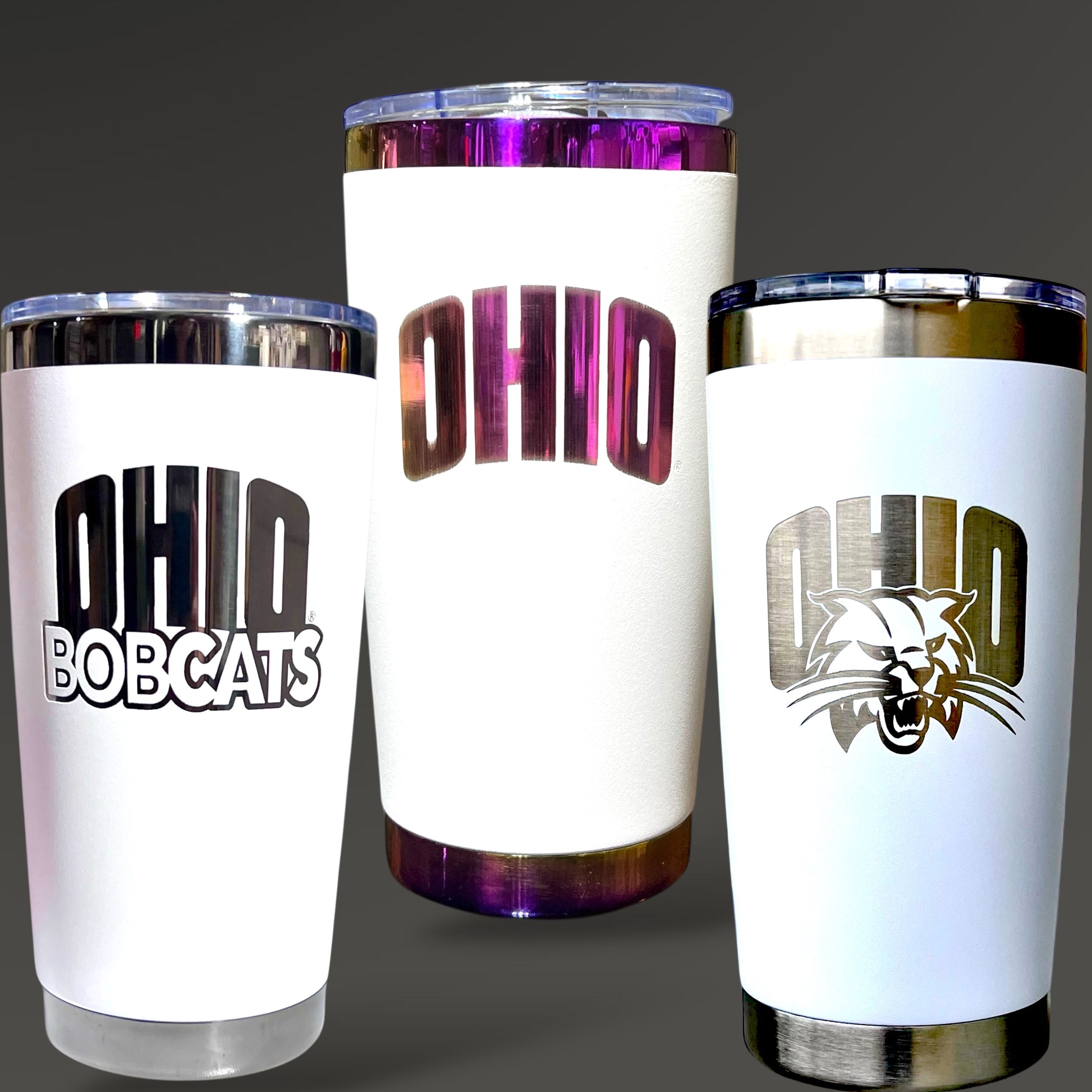 Three white tumblers with 'OHIO' and 'OHIO BOBCATS' text and logo on a dark background