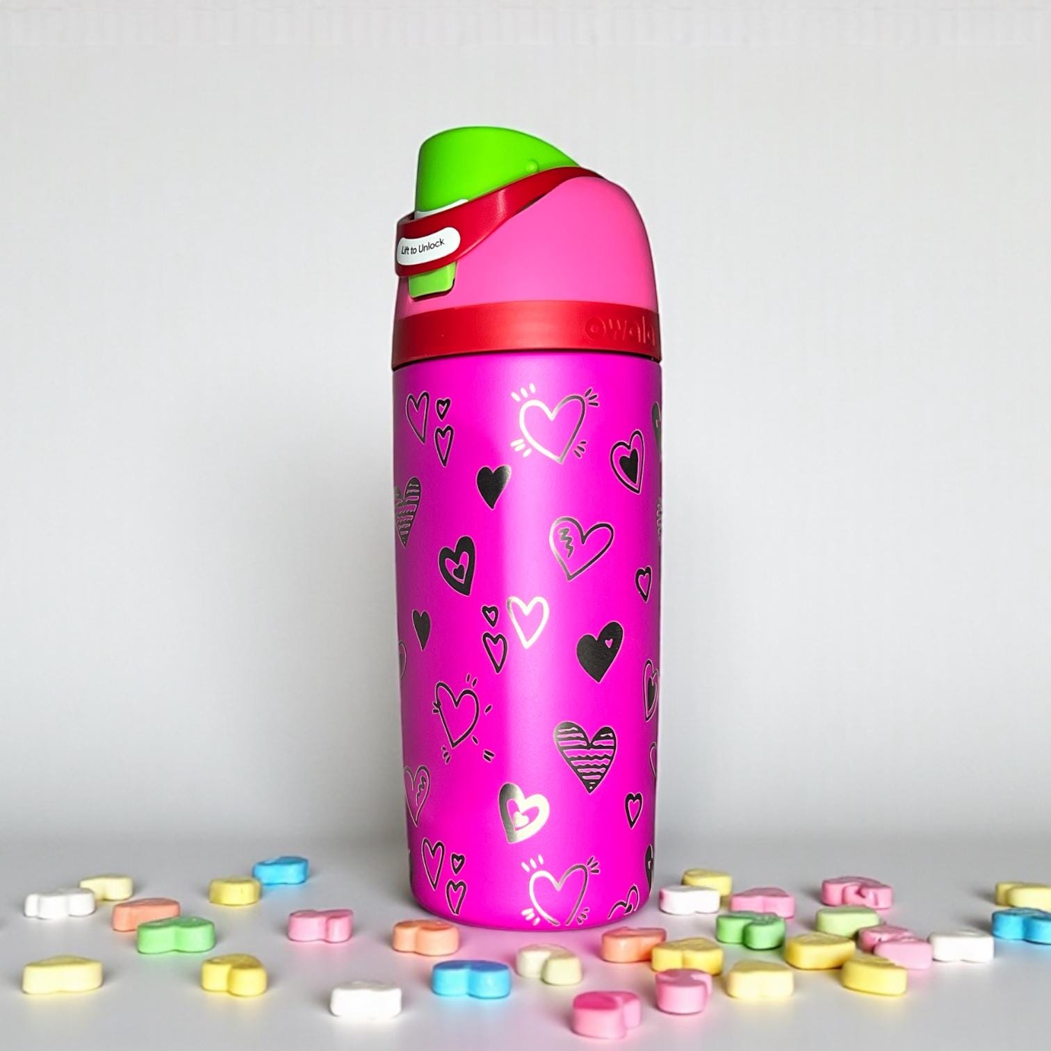 Owala Kids All the Berries color water bottle with heart patterns on a light gray background