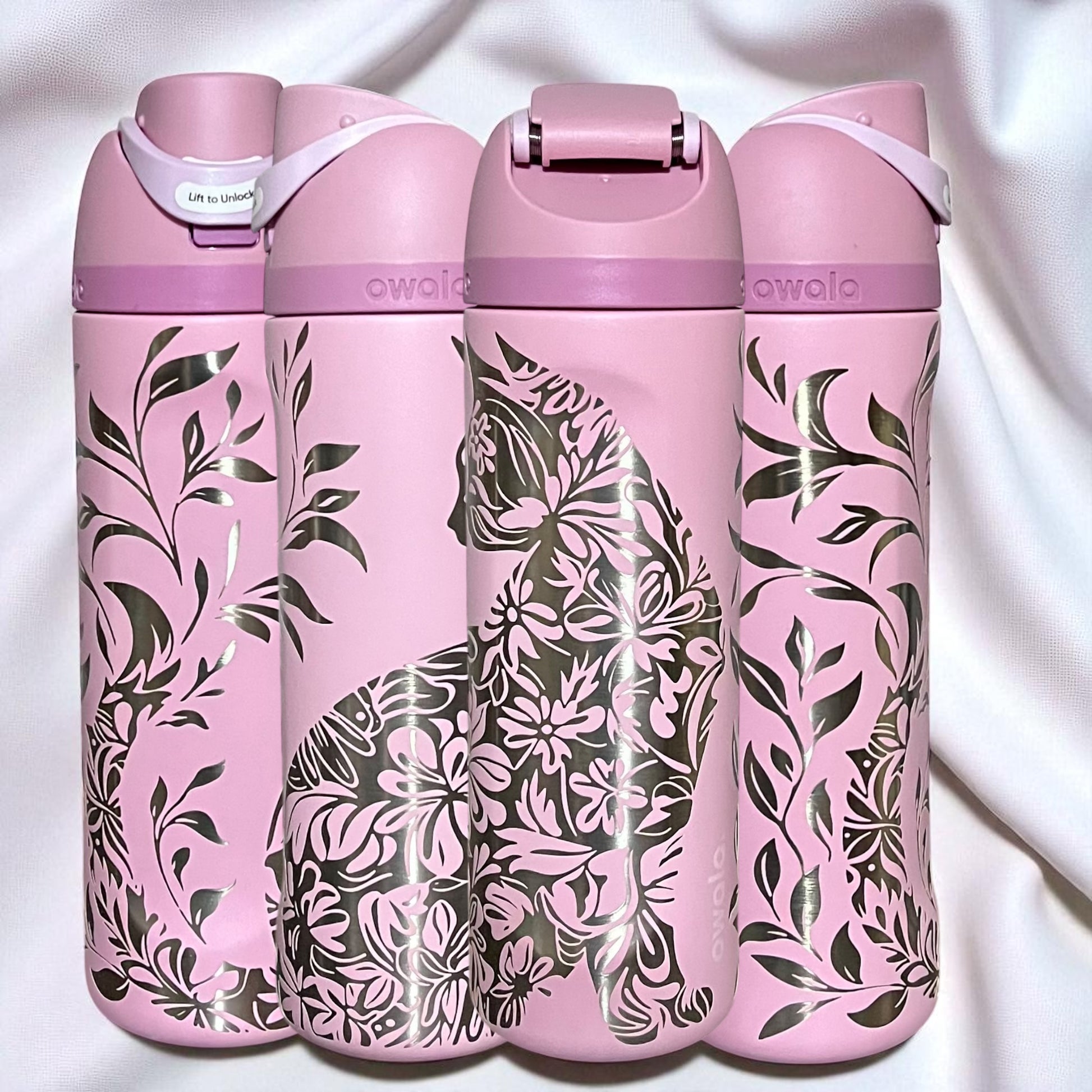 Owala Freesip 24oz water bottle with intricate full-wrap detailed floral cat engraving in rose quartz color