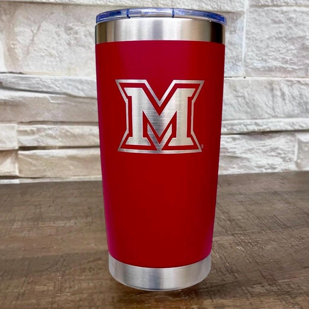 Red coffee tumbler with silver Miami Ohio logo engraved